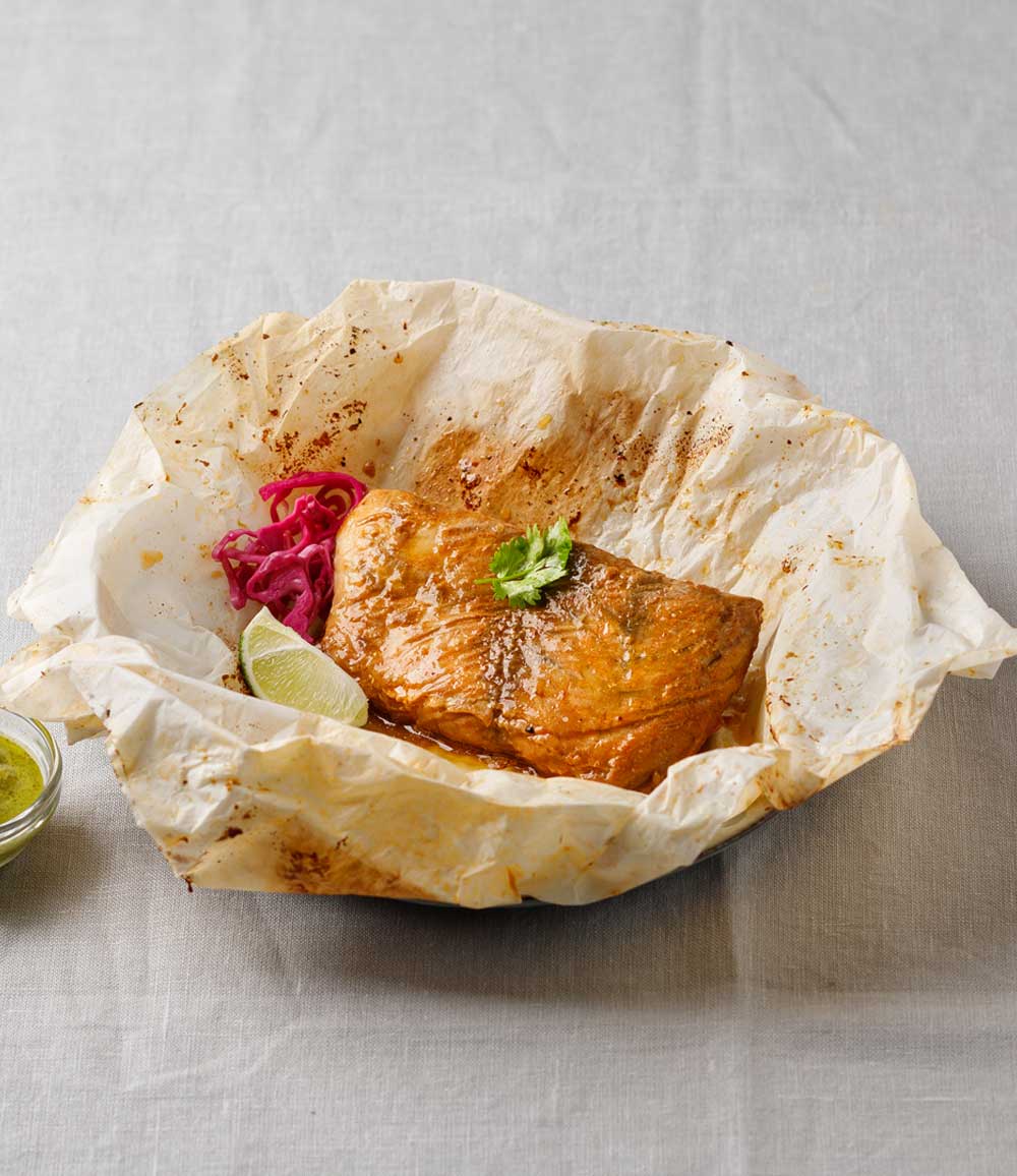 A fish fillet baked in parchment paper